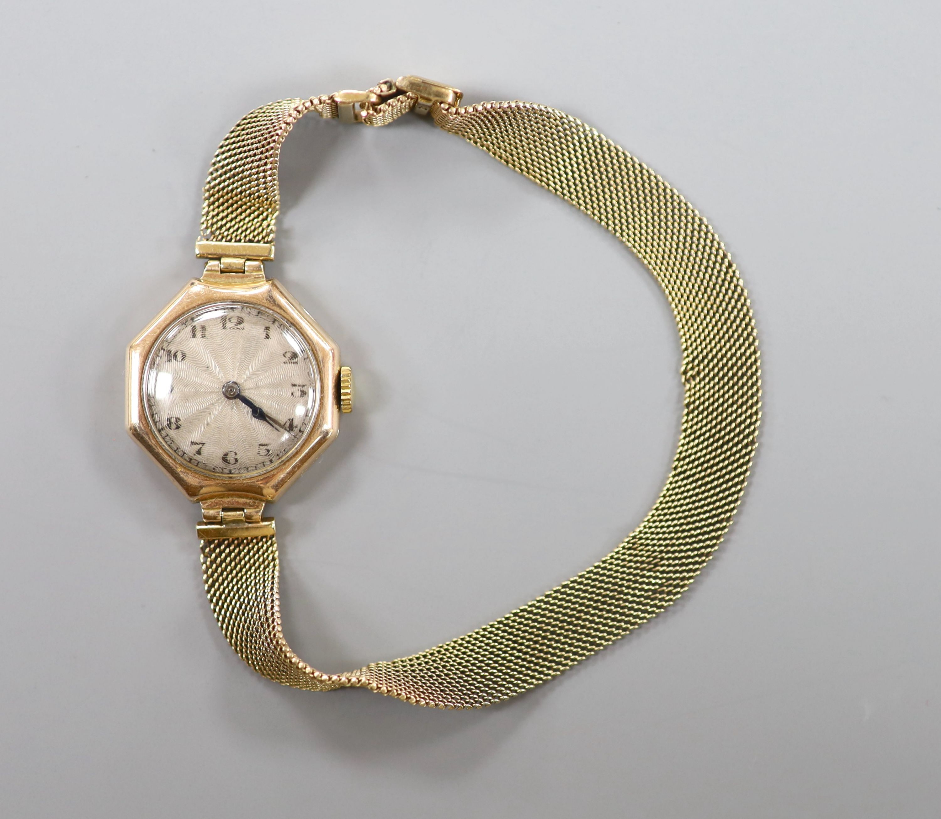 A lady's early 20th century yellow metal manual wind wrist watch, on a 9ct mesh link bracelet